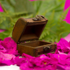 wedding rings and rose wooden box background