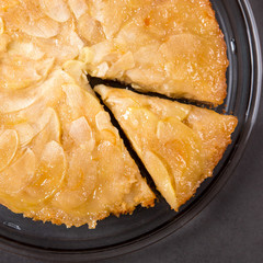 Homemade apple pie on a stone countertop. Appetizing breakfast, author's recipe.