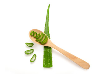 Isolated fresh aloe vera leaves sliced and inside wooden spoon on white background . Aloe vera gel have medical properties for wound healing.