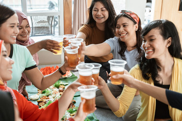 tea time with friend during lunch. muslim asian woman with friends together. toast their glass