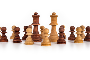 Chess pieces scattered on a table. Still-life picture made in studio with white background and softbox.