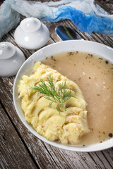 Pure white borscht served with mashed potatoes.