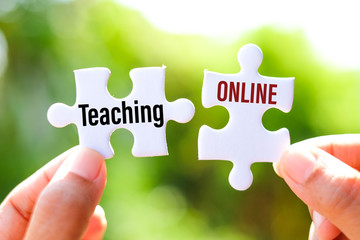 Teaching online (typically refers to courses that are delivered completely online) on white jigsaw...