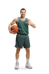 Fototapeta premium Basketball player holding a ball and pointing at it