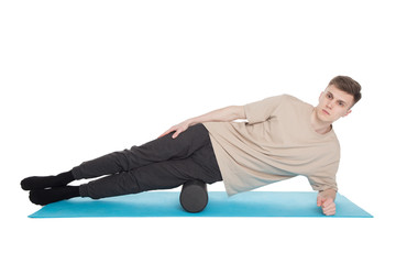 Obraz premium Handsome man shows exercises using a foam roller