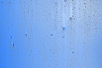 fresh drops background blue glass / wet rainy background, water drops transparent glass blue