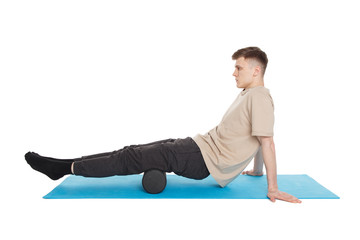 Handsome man shows exercises using a foam roller