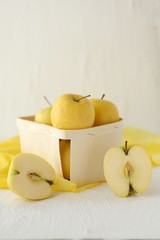 yellow apples at the basket on white background - Symbolic image. Concept for healthy nutrition. Front view. Copy space.