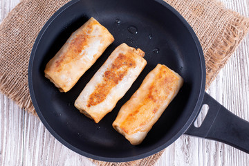 Pancakes with a filling in a frying pan