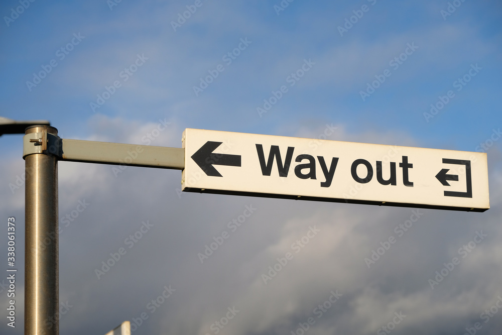 Wall mural a way out sign at a british train station points to the exit