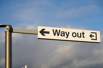 A Way Out sign at a british train station points to the exit