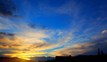 Beautiful yellow orange sunset blue sky. Sunrise. Nature background. Ukraine, Carpathian mountains.