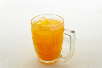 Orange juice ice in a glass on white background