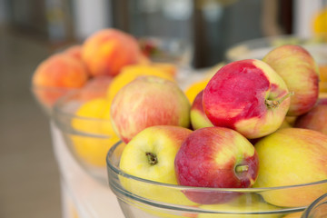 Fresh apple, lemons and peach in the background. Fruit for making fresh juice.