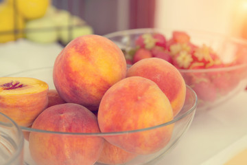 Peaches in a glass dish.