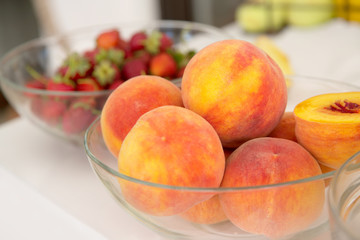 Peaches in a glass dish.