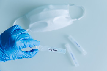 medical mask and test tubes on the white table