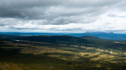 panoramic overview over a valley with forest and lakes in sweden on a cloudy day