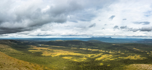 panoramic overview over a valley with forest and lakes in sweden on a cloudy day