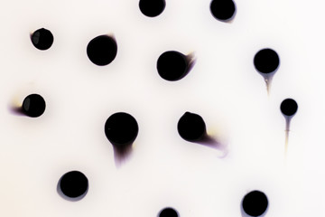 Light creative abstract hand-painted background, marble texture, black dots on milk, acrylic painting fragment on canvas. Contemporary art. Swirl style of marble or ripple agate