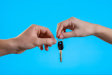 Close up cropped man woman hands present give each other gift car keys isolated on pastel blue background in studio. Birthday holiday valentine day emotions celebration concept. Mock up copy space