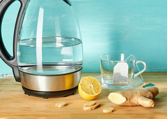 Electric kettle cup, lemon, ginger. Tea with ginger and lemon.