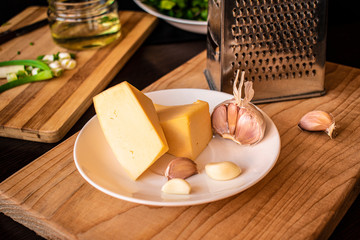 Cheese and garlic on a wooden kitchen Board