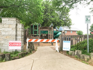 Notice lawn sign with barrier caution at the entrance to kid playground near Dallas, Texas, USA