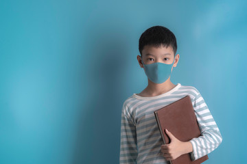 boy in medical face protection mask on blue background