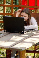 girl learns in the gazebo using the laptop