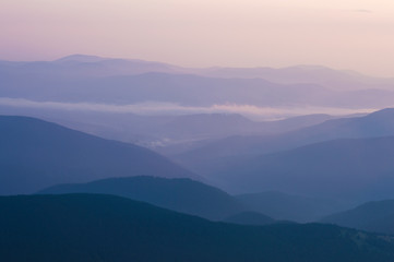 Fototapeta premium silhouette mountains in the haze at sunset time