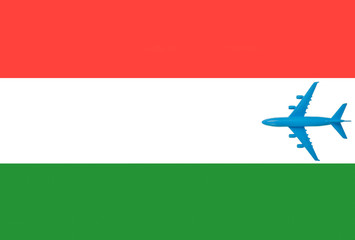 The flag of Hungary and the plane. Toy plane on the Hungarian flag. Concept of a travel