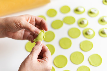 The process of sculpting dumplings. Green dumplings with cheese. Russian dumplings