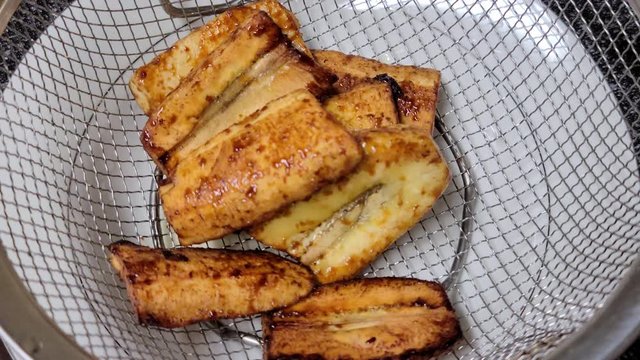Bananacue cooked with brown sugar placed in a strainer