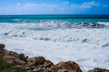 A fresh spring wind drives the waves to the coast of Cyprus. The Mediterranean Sea is painted with dark ultramarine and a luminous azure from the inside.     