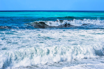 A fresh spring wind drives the waves to the coast of Cyprus. The Mediterranean Sea is painted with dark ultramarine and a luminous azure from the inside.     