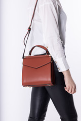  Model girl with leather elegant women bag. Fashionable female handbag, isolated