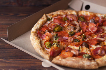 pizza delivery, pizza in a paper box, contactless delivery during the coronavirus epidemic