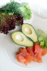 Avocado with red fish and lettuce - healthy breakfast	