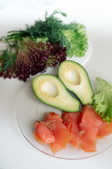 Avocado with red fish and lettuce - healthy breakfast	
