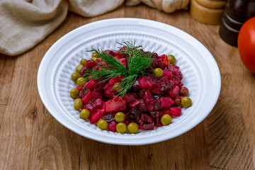 Vinaigrette on a white plate on wooden table