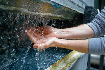 Fototapeta premium Man washing hands in purified water.