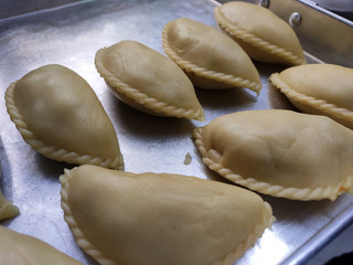 Curry puffs for sale. It is one of the traditional cakes in Malaysia. Skin made from the wheat flour mixture and the inside is potato and curry mixture.