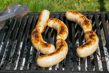 Delicious german sausages on the barbecue grill