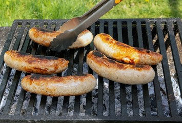 Delicious german sausages on the barbecue grill