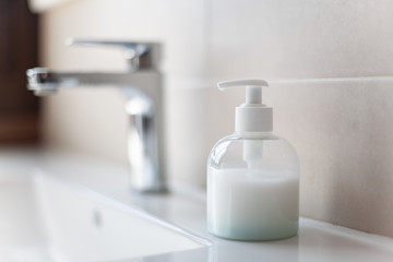 Fototapeta na wymiar Sink soap dispenser to prevent coronavirus