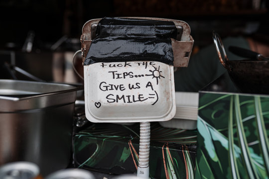 Funny message written on a street restaurant sign. The kindness and hearts of people have no limit. Street art in the purest London style.