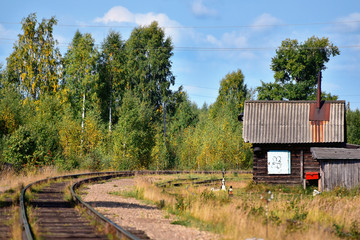 A house near the railway in the autumn deciduous forest