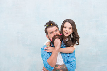 daughter and father with funny hairdo. hairdresser and barbershop. happy family day. small girl...