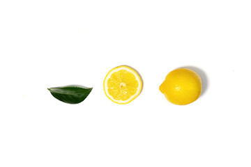 Creative layout made of lemon and green leaf.
